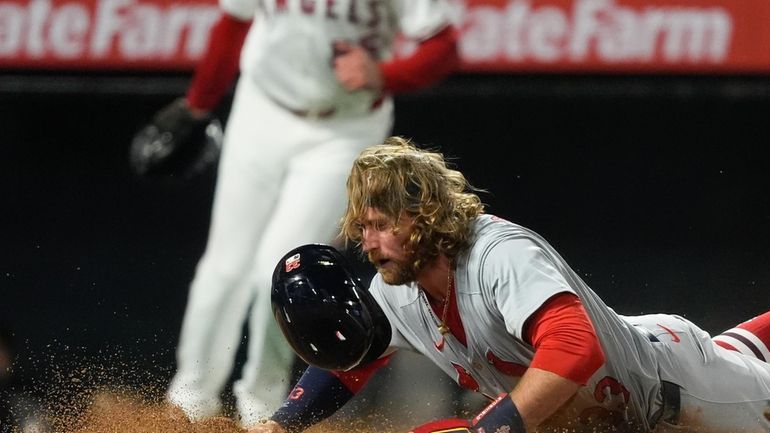 St. Louis Cardinals' Brendan Donovan slides home to score off...