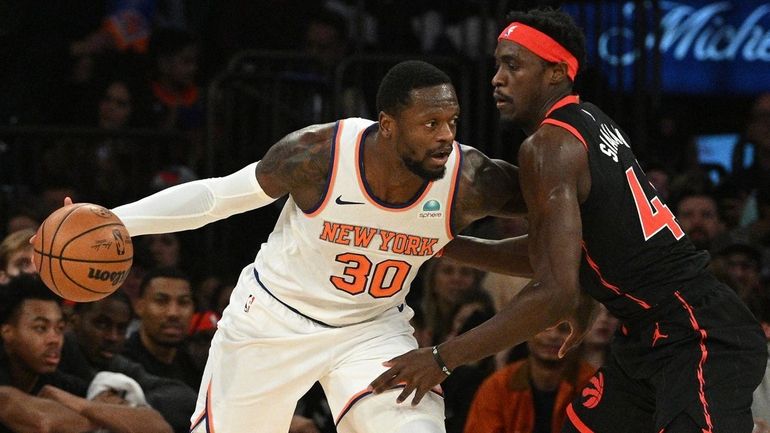 Knicks forward Julius Randle drives against Raptors forward Scottie Barnes...