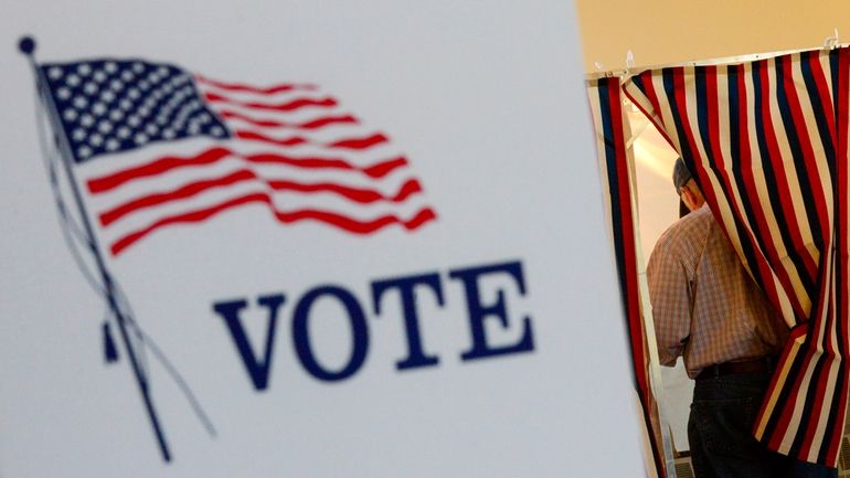 Lyell Williams of Chesterfield, N.H., fills out his ballot during...