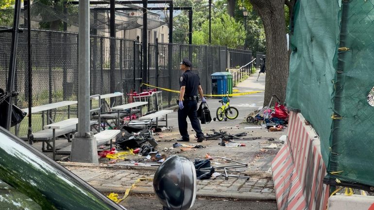 New York City authorities work a crime scene of a...