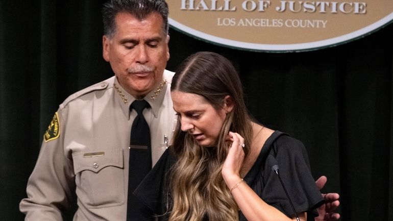 Los Angeles County Sheriff Robert Luna, left, comforts sheriff's deputy...