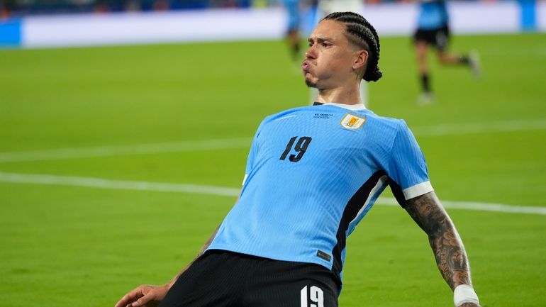 Uruguay's Darwin Nunez celebrates after scoring his side's 2nd goal...