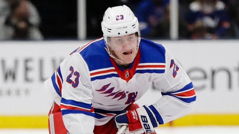 The Rangers' Adam Fox controls the puck during the first...