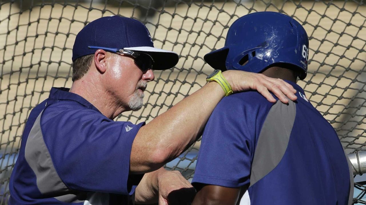 St. Louis Cardinals manager Mike Matheny and Mark McGwire watch