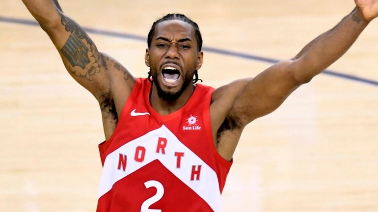 The Raptors' Kawhi Leonard celebrates after the buzzer as the...