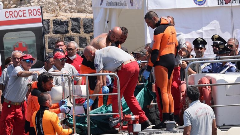 Italian firefighter divers bring ashore in a plastic bag the...