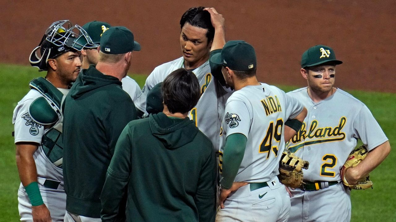 Shintaro Fujinami of the Oakland Athletics pitches against the Milwaukee  Brewers in a spring training game