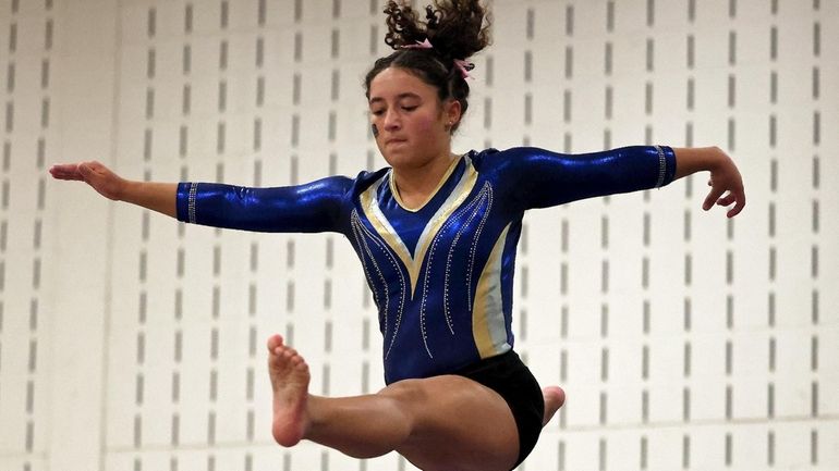 West Babylon gymnast Olivia Stuart performs on the balance beam...