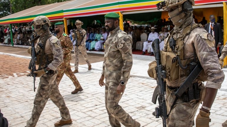 Leader of Mali's ruling junta Lt. Col. Assimi Goita, center,...