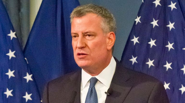 New York Mayor Bill de Blasio speaks at City Hall...