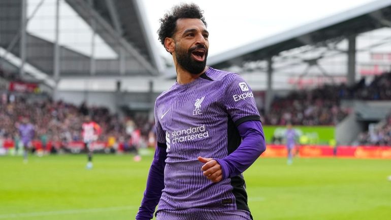 Liverpool's Mohamed Salah celebrates scoring his sides third goal during...