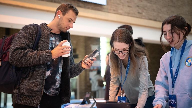 Domenico Pensa III, a Hofstra law student, checks his voter registration...