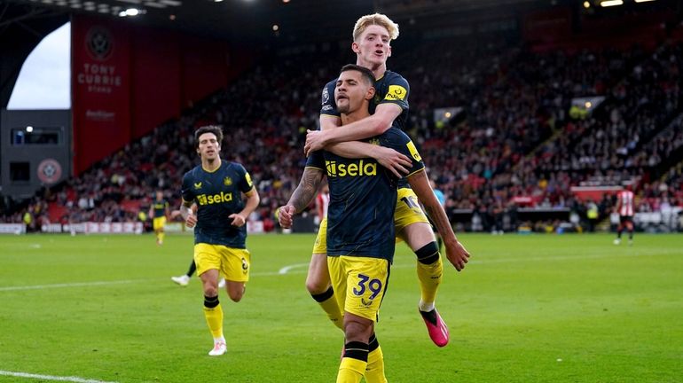 Newcastle United's Bruno Guimaraes celebrates with teammate Anthony Gordon after...