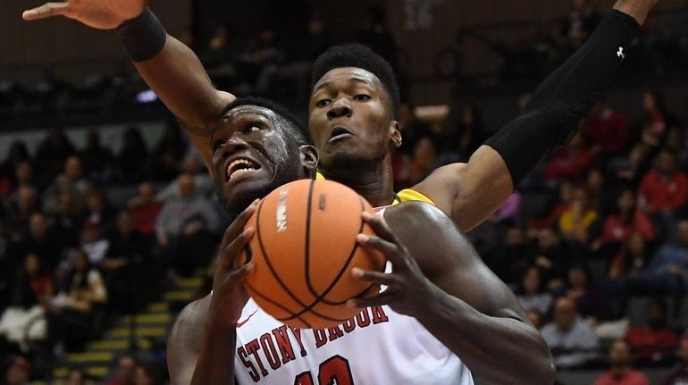 Stony Brook's Tyrell Sturdivant (17 points) drives against Maryland's Bruno...