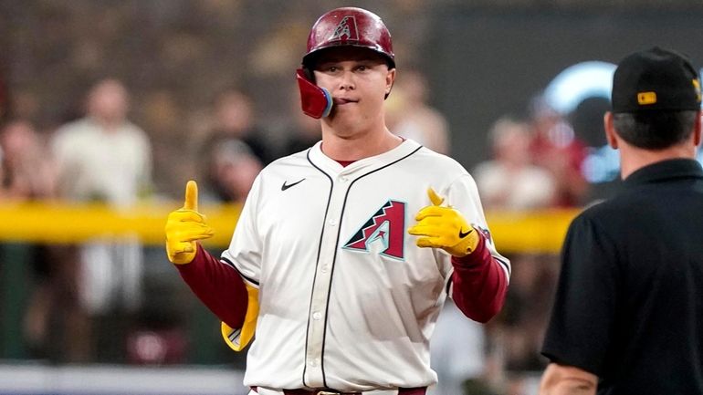 Arizona Diamondbacks' Joc Pederson gestures toward his dugout after hitting...