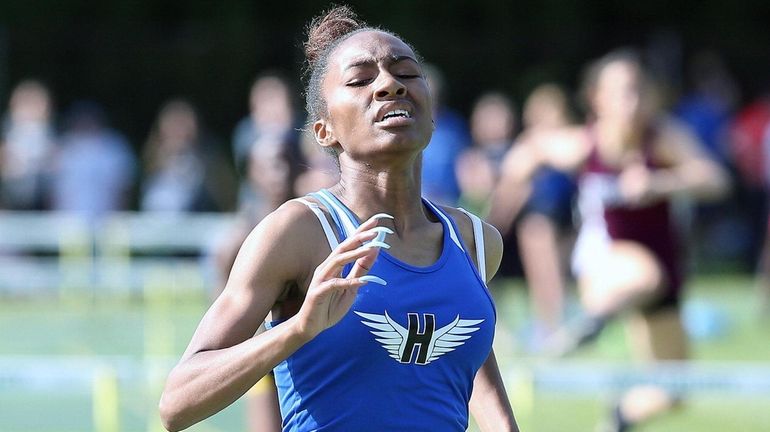 Rene''e Newton from Hempstead takes first in the girls 400-meter...