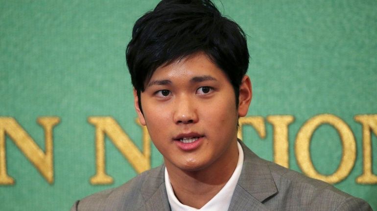 Pitcher-outfielder Shohei Ohtani speaks during a press conference at Japanese...