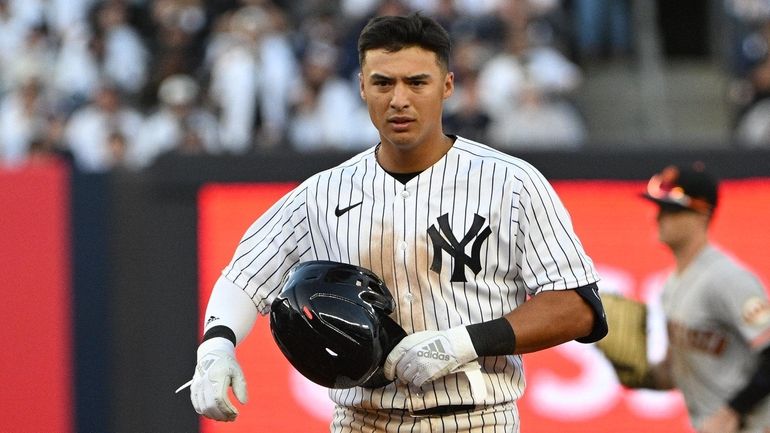 Yankees shortstop Anthony Volpe looks on after he flew out...