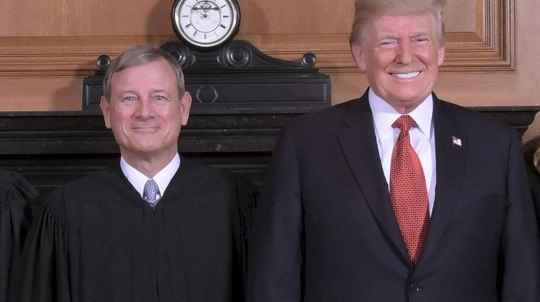 Supreme Court Chief Justice John G. Roberts is seen with...