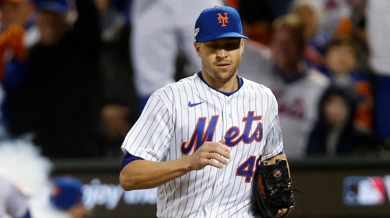 Jacob deGrom #48 of the Mets leads his team on the...