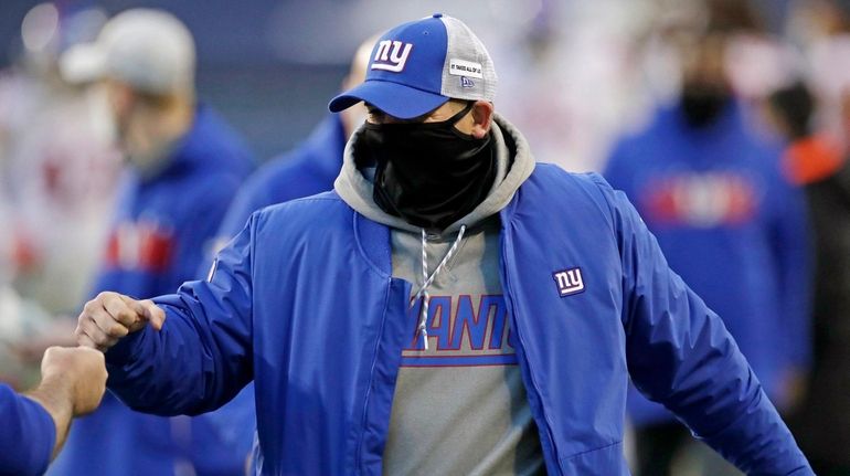 Giants head coach Joe Judge is greeted after an NFL...