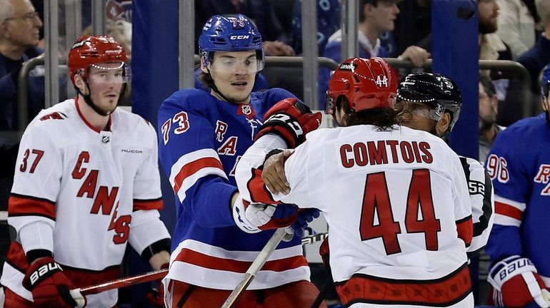 Matt Rempe #73 of the Rangers and Max Comtois #44 of...