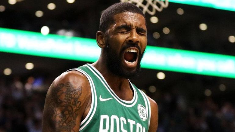 Celtics guard Kyrie Irving celebrates during a game against the...