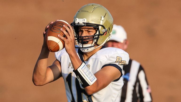 Bayport-Blue Point quarterback Brady Clark fades back to pass during...