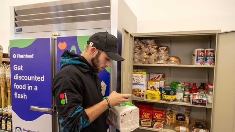 Supervisor Ray Miller organizes the Flashfood pantry at Stop &...