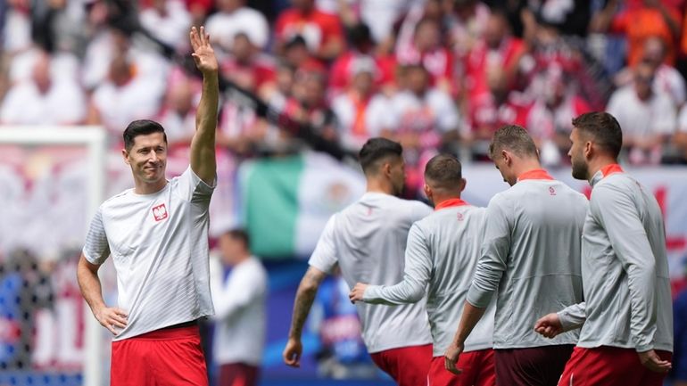 Poland's Robert Lewandowski, left, greets supporters prior to the Group...