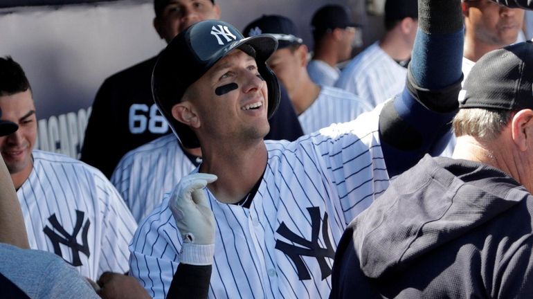 The Yankees' Troy Tulowitzki celebrates in the dugout after hitting...