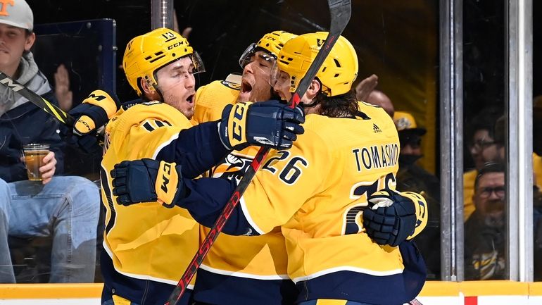 Nashville Predators left wing Kiefer Sherwood, center, celebrates with Colton...