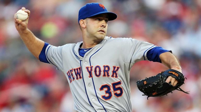 Starting pitcher Dillon Gee of the Mets throws to a...