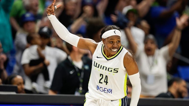 Dallas Wings guard Arike Ogunbowale (24) celebrates a three-point shot...