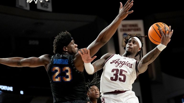 Texas A&M guard Manny Obaseki (35) shoots past Memphis forward...