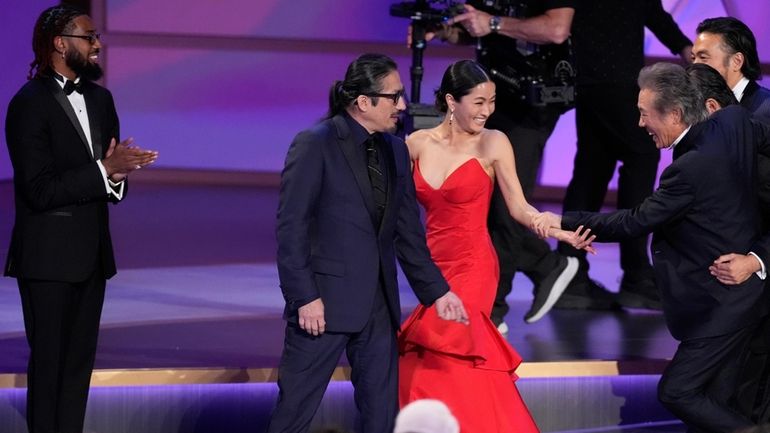 Hiroyuki Sanada, left, and Anna Sawai accept the award for...