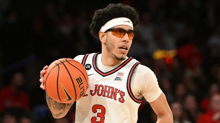 St. John's Red Storm guard Andre Curbelo controls the ball...