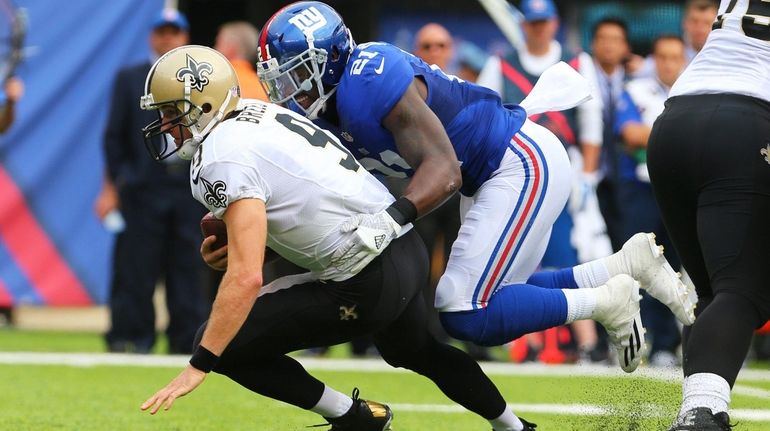 Landon Collins of the Giants sacks Drew Brees of the...