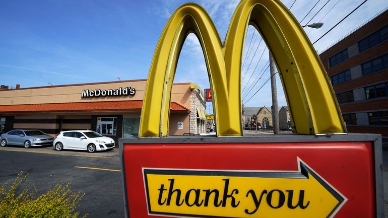 A sign is shown in front of an McDonald's restaurant...