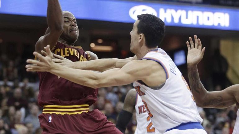 Cavaliers' Jarrett Jack passes over Knicks' Pablo Prigioni during the...