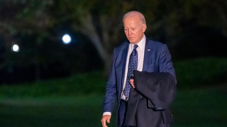 President Joe Biden walks from Marine One upon arrival on...