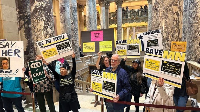 Protesters demanding the resignation of state Sen. Nicole Mitchell, D-Woodbury,...