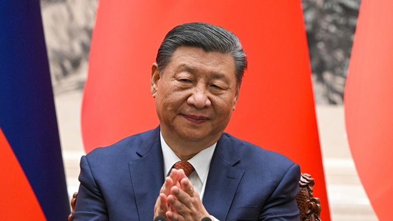 Chinese President Xi Jinping applauds during a signing ceremony at...