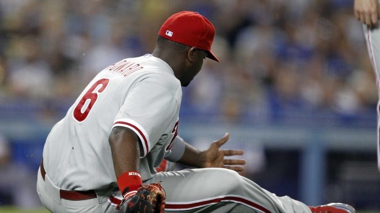 Philadelphia Phillies first baseman Ryan Howard slips and falls onto...