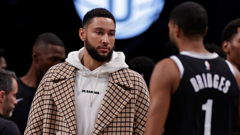 Nets guard Ben Simmons greets Mikal Bridges (1) walking to...