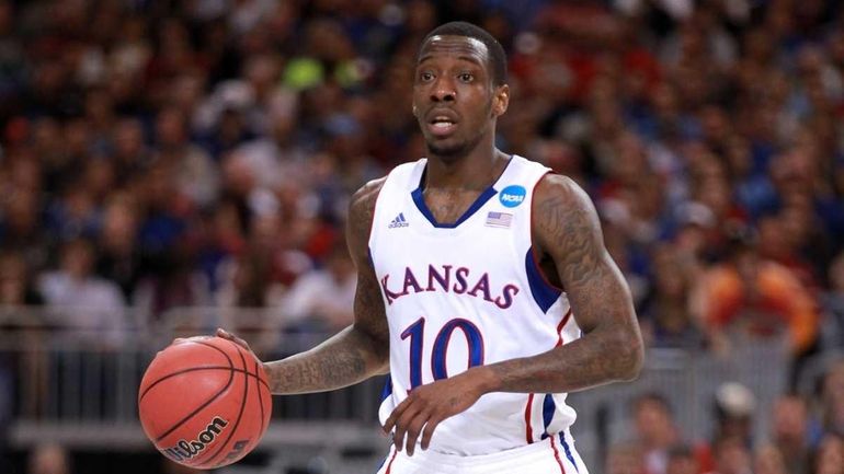 Tyshawn Taylor of the Kansas Jayhawks brings the ball up...