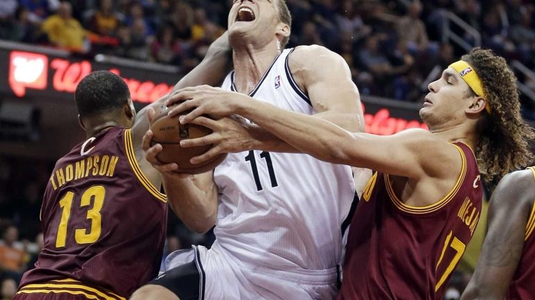 Brooklyn Nets' Brook Lopez is stopped by Cleveland Cavaliers' Tristan...