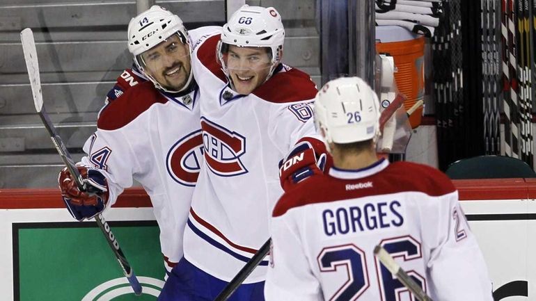 Montreal Canadiens forward Tomas Plekanec (14), Yannick Weber (68), and...