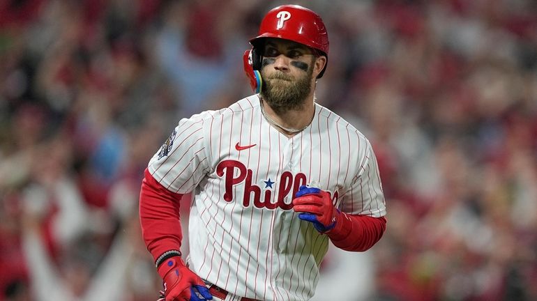 FILE - Philadelphia Phillies' Bryce Harper celebrates his two-run home...