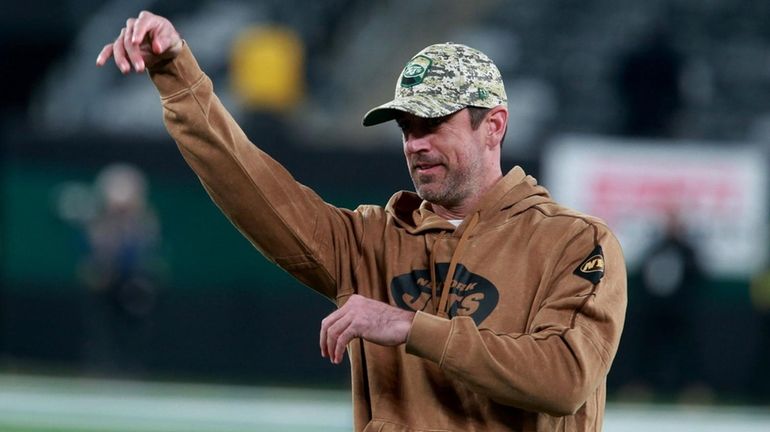 Jets QB Aaron Rodgers tosses the ball before a game...